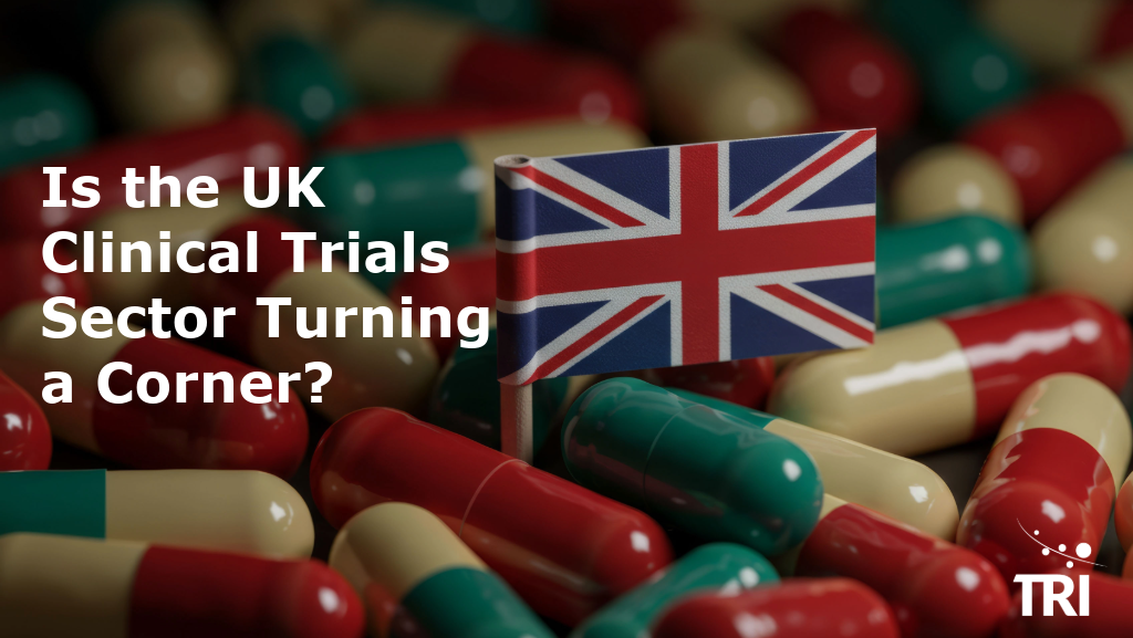 Copilot said: Alt text: Union Jack flag among red, green and cream capsules, with the title “Is the UK Clinical Trials Sector Turning a Corner?” and the TRI logo.